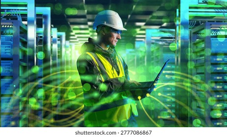 Data center technician monitors server network systems with laptop.