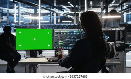 Data center technician using node tree software on green screen PC to analyze datasets. Server room worker using visual programming tools on chroma key computer to improve gear performance, camera A