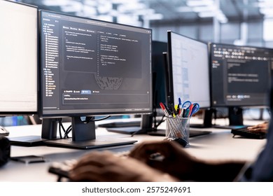 Data center technician using programming languages on PC to construct algorithms and build applications. Close up of server hub IT professional debugging and optimizing code