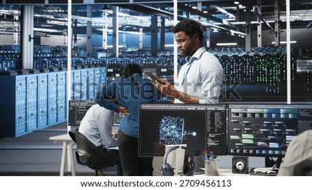Data center technician using tablet to do node tree programming, optimizing resource allocation. Server room IT expert using predictive AI visualization systems for maintenance planning, camera A