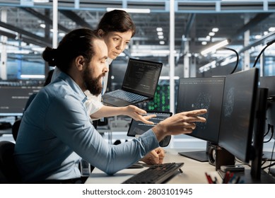 Data center worker monitors system performance and troubleshoots software issues affecting server operations.