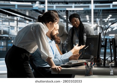 Data center worker monitors system performance and troubleshoots software issues affecting server operations.