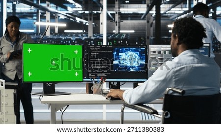 Data center worker with paraplegia using green screen PC to apply node tree programming. Server hub admin with disability uses visual programming on mockup computer to identify data patterns, camera B