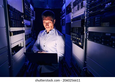 Data center IT worker staring at his notebook computer