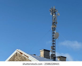Data communication tower on the building roof, 5g tower, mobile data transfer  