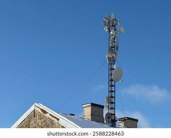 Data communication tower on the building roof, 5g tower, mobile data transfer  