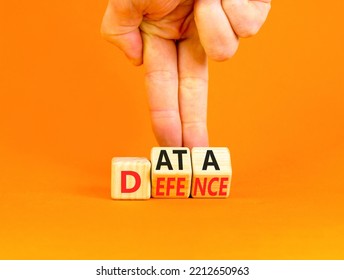 Data defence symbol. Concept words Data defence on wooden cubes. Beautiful orange table orange background. Businessman hand. Business and cyber crime concept. Copy space.