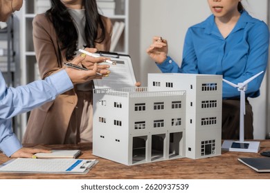Data Driven Decisions: A team of professionals analyze data on a laptop, collaborating on strategy and insights. They point at charts and graphs, demonstrating their expertise and focus on results.	