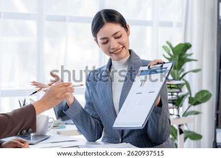 Data Driven Decisions: A team of professionals analyze data on a laptop, collaborating on strategy and insights. They point at charts and graphs, demonstrating their expertise and focus on results.	