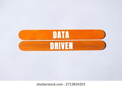 Data Driven message written on wooden stick background. Conceptual Data Driven symbol. Copy space.