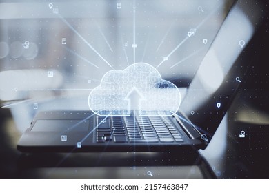 Data and information storage concept with digital cloud technology sign with arrow inside on modern laptop background, double exposure