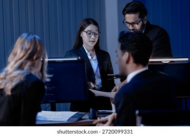 Data integrity check night shift Diverse team meticulously audits financial performance comparing figures tablet screen printed reports ensuring accuracy crucial validation process underway hub.