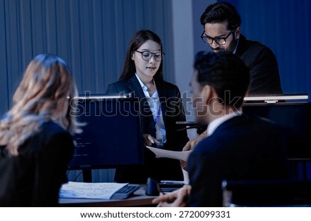 Data integrity check night shift Diverse team meticulously audits financial performance comparing figures tablet screen printed reports ensuring accuracy crucial validation process underway hub.
