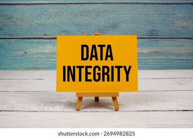 Data Integrity text written on paper card on wooden background