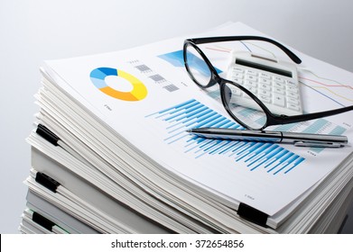 Data management. Document management. Business concept.
Pile of documents on gray background. Graph, glasses, calculate and pen.
 - Shutterstock ID 372654856