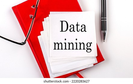 DATA MINING Text On Sticker On A Red Notebook With Pen And Glasses