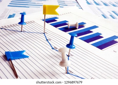 Data Points. Thumb tacks on a business graph as marks.