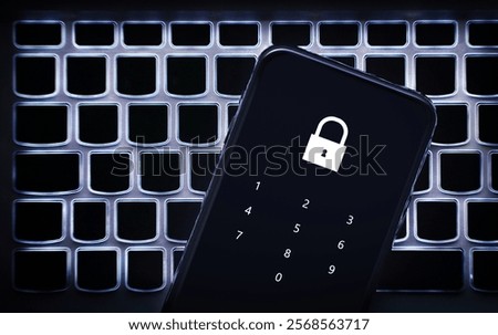 Data privacy in phone with password code. Smartphone on laptop keyboard. Lock to protect personal bank from hacker, cyber fraud or online scam. Protection with 2fa verification. Pin number.