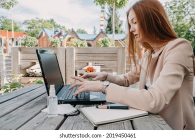 Data privacy, data wellbeing, management, personal information, digital identity, digital behavior, security issue, data hygiene, cybersecurity. Redhead woman entering data on laptop