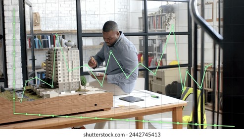 Data processing on graph over african american male architect studying building model. Architecture, design, business, data, digital interface, connection and communication digitally generated image. - Powered by Shutterstock - Get 15% off with code: PIKWIZARD15