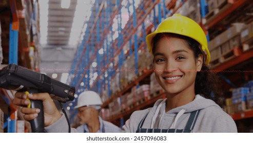 Data processing over portrait of african american female worker scanning stock at the warehouse. Global finance and logistics business concept - Powered by Shutterstock