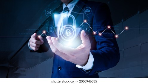 Data Protection And Cyber Security. A Padlock Is Used By A Businessman To Secure Commercial And Financial Data Over A Virtual Network Connection. Innovative Technology Produce Brilliant Solutions.