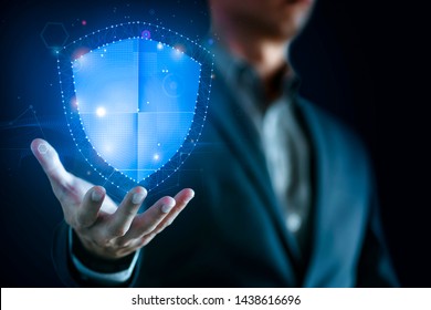 Data Protection And Network Security Concept. Glowing Light Shield On Business Man Hand For Internet Fire Wall Protect, Insurance, Or Computer Virus Cleaner.