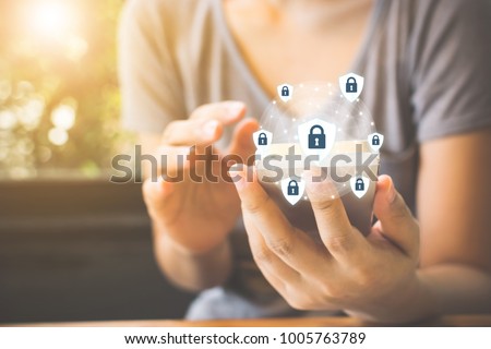 Data protection and security important information in your mobile phone, Woman hand using smartphone and icon key on shield