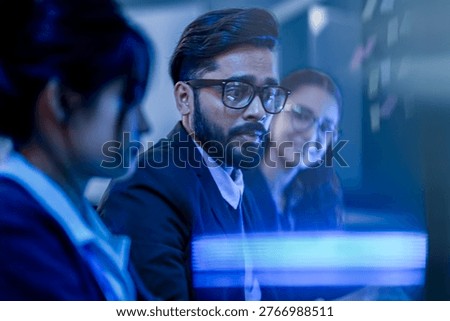 Data science professional evaluating predictive machine learning algorithms. Female analyst interpreting algorithmic trading metrics on digital dashboard in tech office.