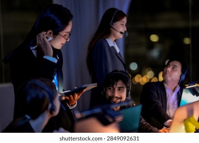 A data science team debugging software after hours inside a low-light innovation lab, showing modern teamwork, technology and digital innovation with intense after-hours concentration.