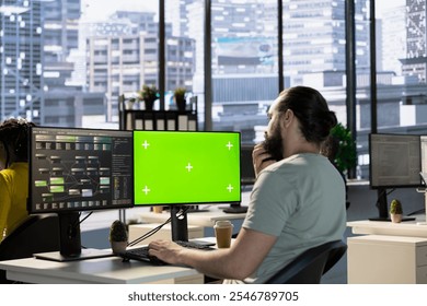 Data scientist using green screen PC to create machine learning models that can process data to automate decision making processes. IT expert programming in office using chroma key computer