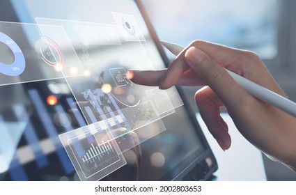 Data scientists, Business woman touching on digital tablet computer analyzing business report, financial graph on futuristic virtual interface screen. Algorithm,  marketing and business intelligence - Shutterstock ID 2002803653