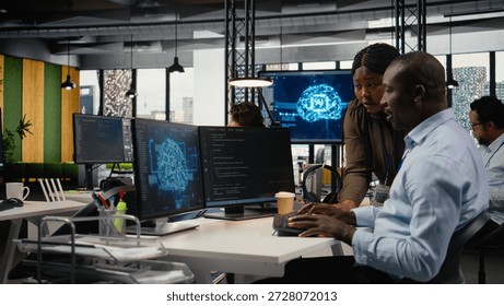 Data scientists doing brainstorming in office, using specialized hardware to accelerate complex AI calculations. IT professionals collaborating, managing deep learning datasets systems, camera A