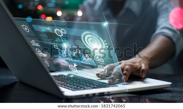Data scientists. Man programmer using laptop\
analyzing and development at various information on futuristic\
virtual interface screen. Algorithm. marketing and deep learning of\
artificial intelligence