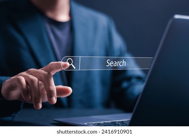 Data search technology search engine optimization concept. Businessman using laptop with virtual Search bar for data search on website online.