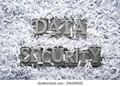 data security phrase made from metallic letterpress type inside of shredded paper heap