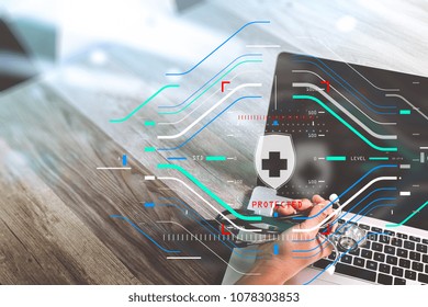 Data Security system Shield Protection Verification concept.Doctor hand working with stethoscope and laptop computer digital tablet with dashboard interface