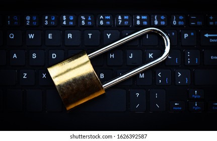Data security systems computer with locked padlock on keyboard for protect crime by an anonymous hacker internet and data network / technology background cyber security concept