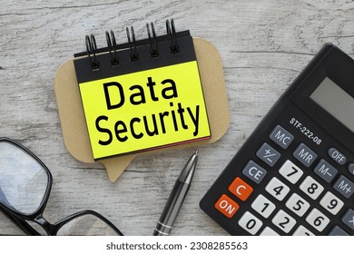 DATA SECURITY text on the sticker . text on yellow paper. wooden background - Shutterstock ID 2308285563