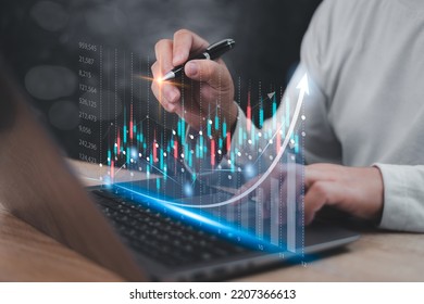 Data statistical index graph on virtual screen concept , Businessman use laptop and point development on stock market data and stock exchange, stock market financial analysis graph.