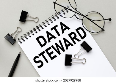 Data Steward. Notepad On Gray Background Near Black Stationery Clips And Glasses