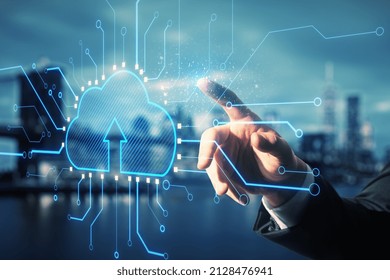 Data storage and cloud technology concept with businessman forefinger on digital interface with cloud icon and circuit lines around on blurry city background