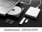 data storage devices connected to a laptop, data security, digital data storage, laptop open optical drive with disk