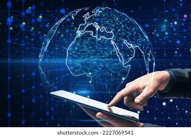 Data stream and big data concept with man hand using digital tablet on abstract dark background with blurred dots and lines and illuminated world map globe