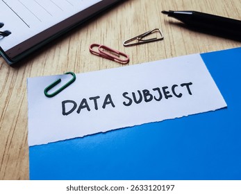 Data subject writting on table background.