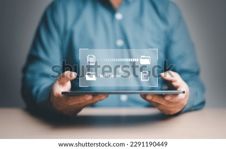Data Sync concept, Transfer file of data between folder, Backup data, Exchange of file on folder, Send document in internet, DMS. Virtual document loading to another folder and hand holding tablet.