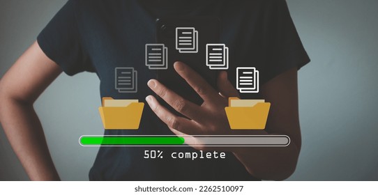 Data transfer concept. Copy files, data exchange, Files transfer. Person hand using mobile smart phone waiting for transfer file process with loading bar icon on virtual screen. - Shutterstock ID 2262510097