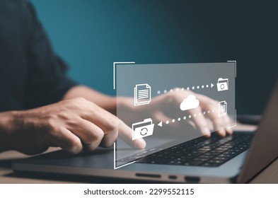 Data Transfer concept. FTP (File Transfer Protocol) files receiver and computer backup. Office man use laptop to copy or sharing document data. Digital system for transferring documents files online. - Powered by Shutterstock - Get 15% off with code: PIKWIZARD15