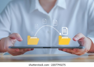 Data transfer, Transfer file of data between folder, Backup data, Exchange of file on folder, Send of document in internet, DMS. Virtual document loading to another folder and hand holding laptop.