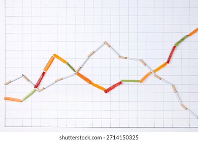 Data visualization with colored sticks on grid paper showing trends and changes over time